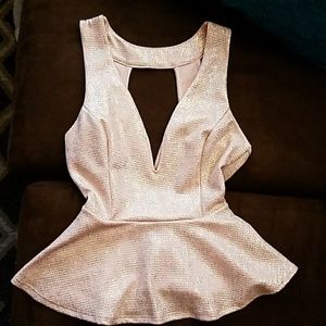 Light pink shiny open back peplum top